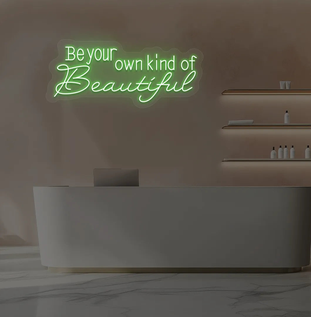 Green "be your own kind of beautiful" LED neon sign for beauty studio setup.