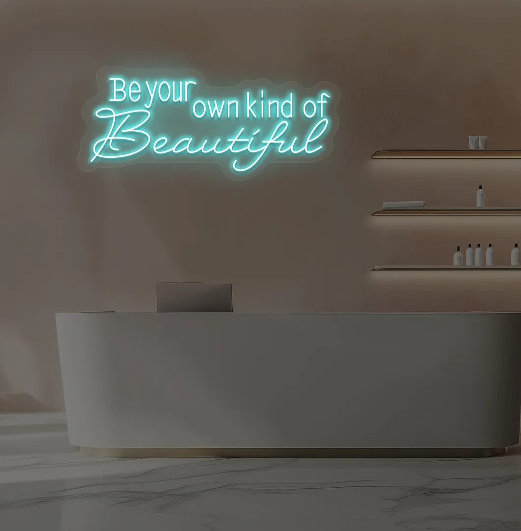 Image of a bright ice blue "be your own kind of beautiful" neon sign for salon wall decor.