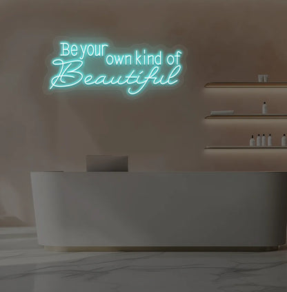Image of a bright ice blue "be your own kind of beautiful" neon sign for salon wall decor.