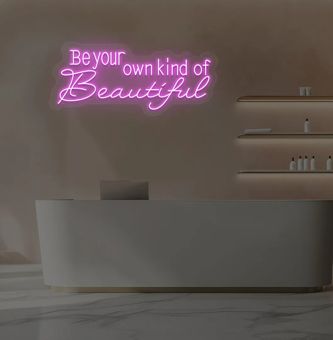 Image of a bright pink "be your own kind of beautiful" neon sign for salon wall decor.