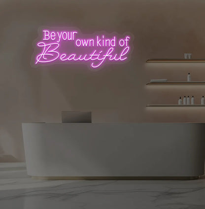 Image of a bright pink "be your own kind of beautiful" neon sign for salon wall decor.