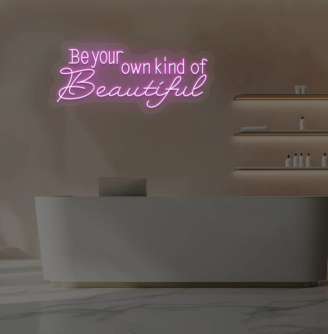 Purple "be your own kind of beautiful" LED neon sign for beauty studio setup.