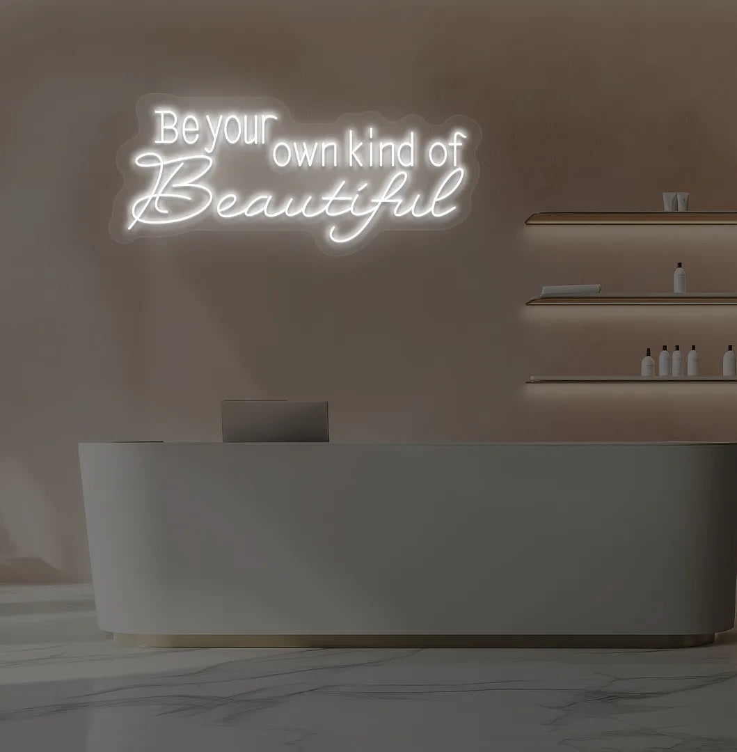 Image of a bright white "be your own kind of beautiful" neon sign for salon wall decor.