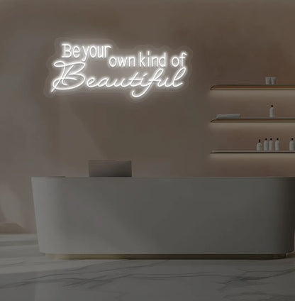 Image of a bright white "be your own kind of beautiful" neon sign for salon wall decor.