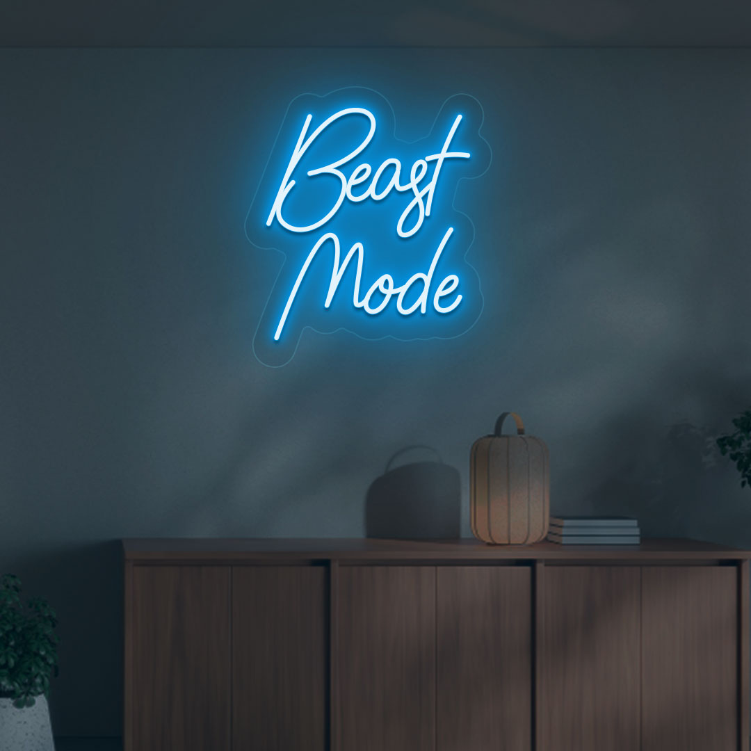 A stylish ice blue LED beast mode neon sign is glowing on the gym wall.