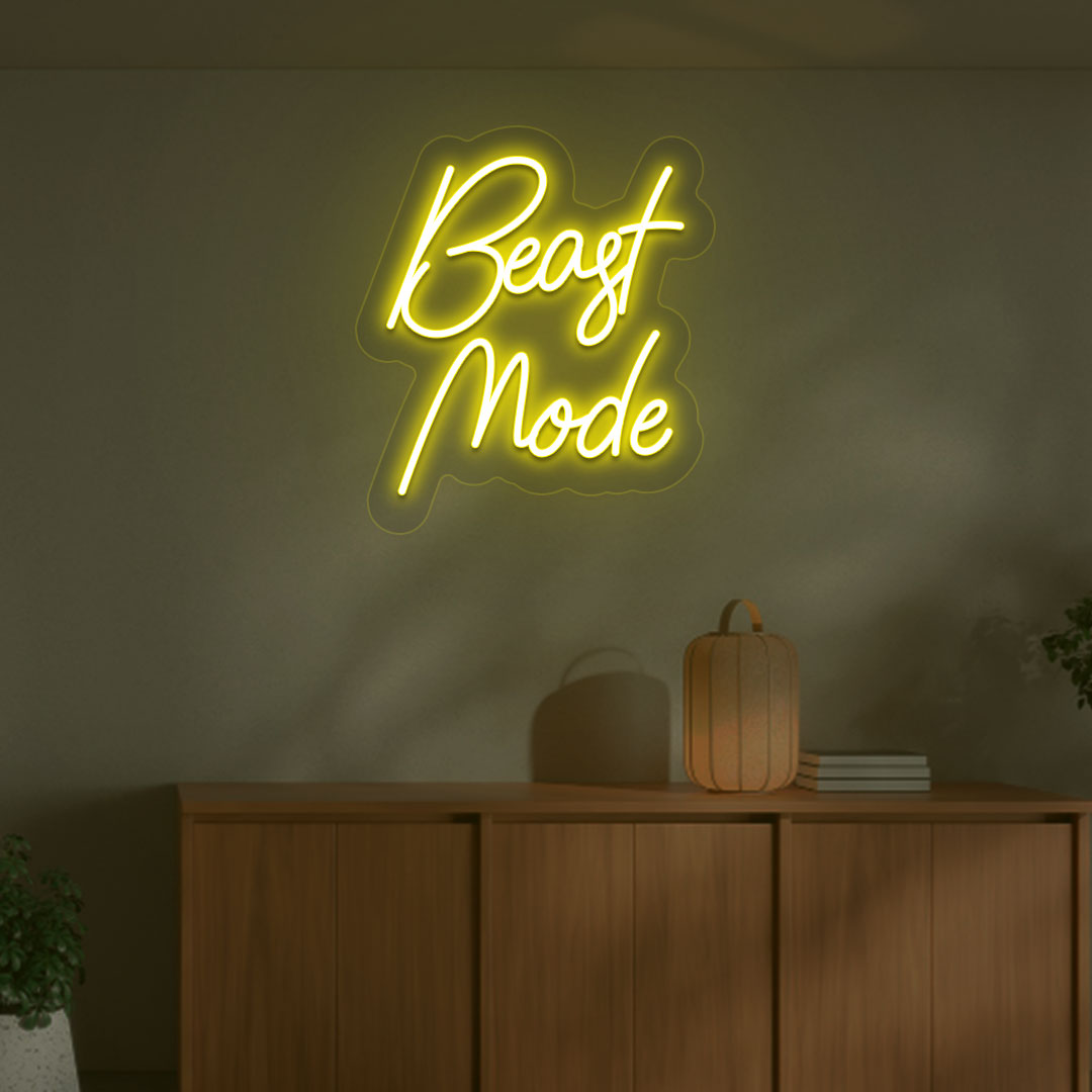 A stylish yellow LED beast mode neon sign is glowing on the gym wall.