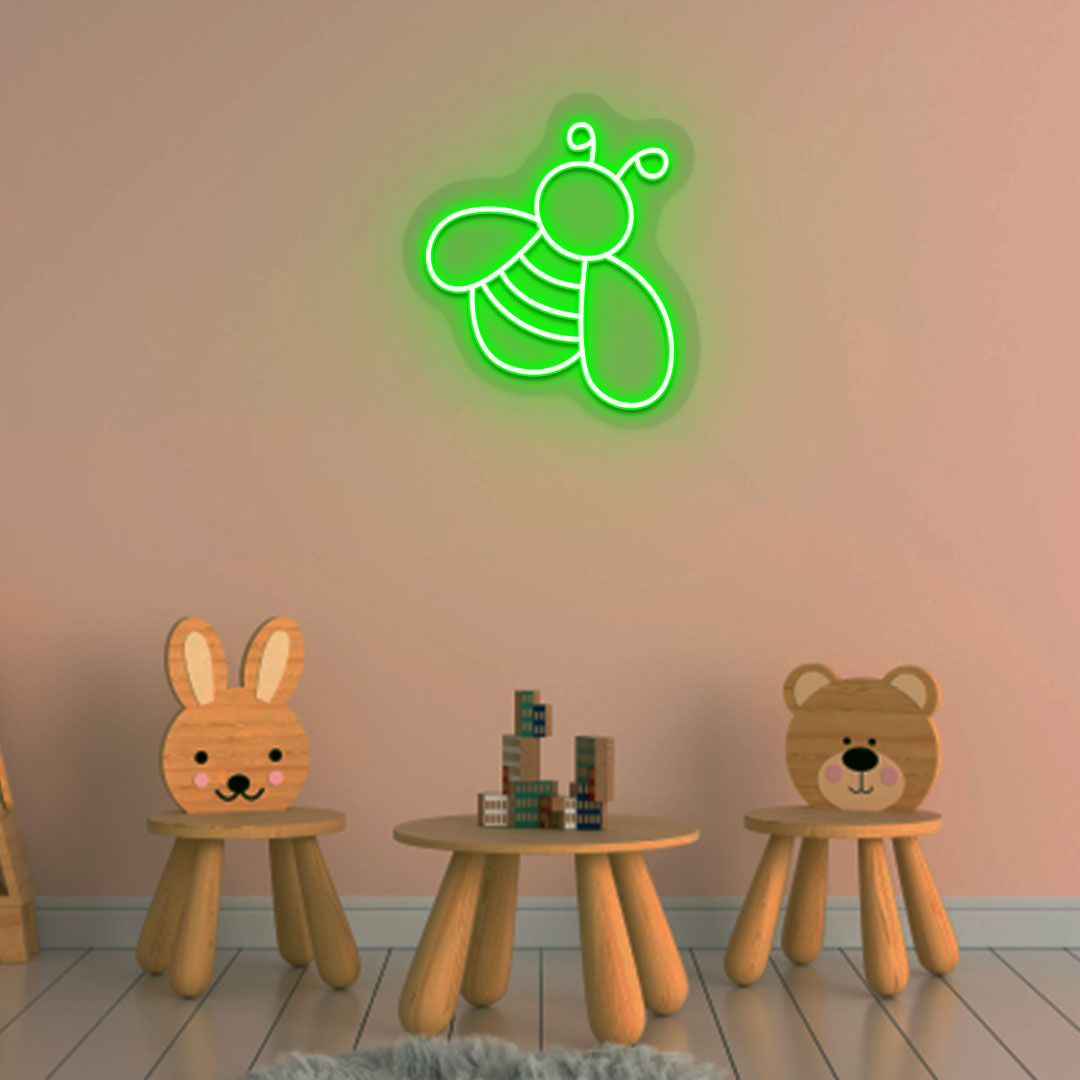 Image of a bee LED neon sign glowing on a kid's room wall in green color.