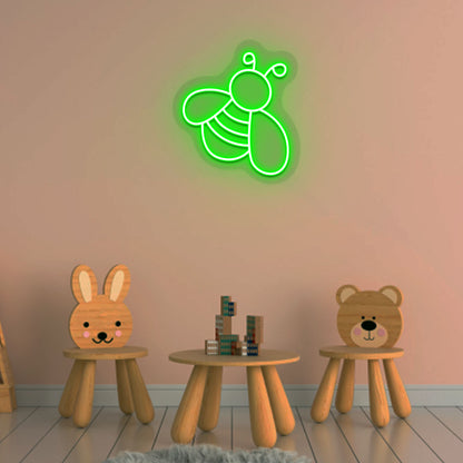 Image of a bee LED neon sign glowing on a kid's room wall in green color.