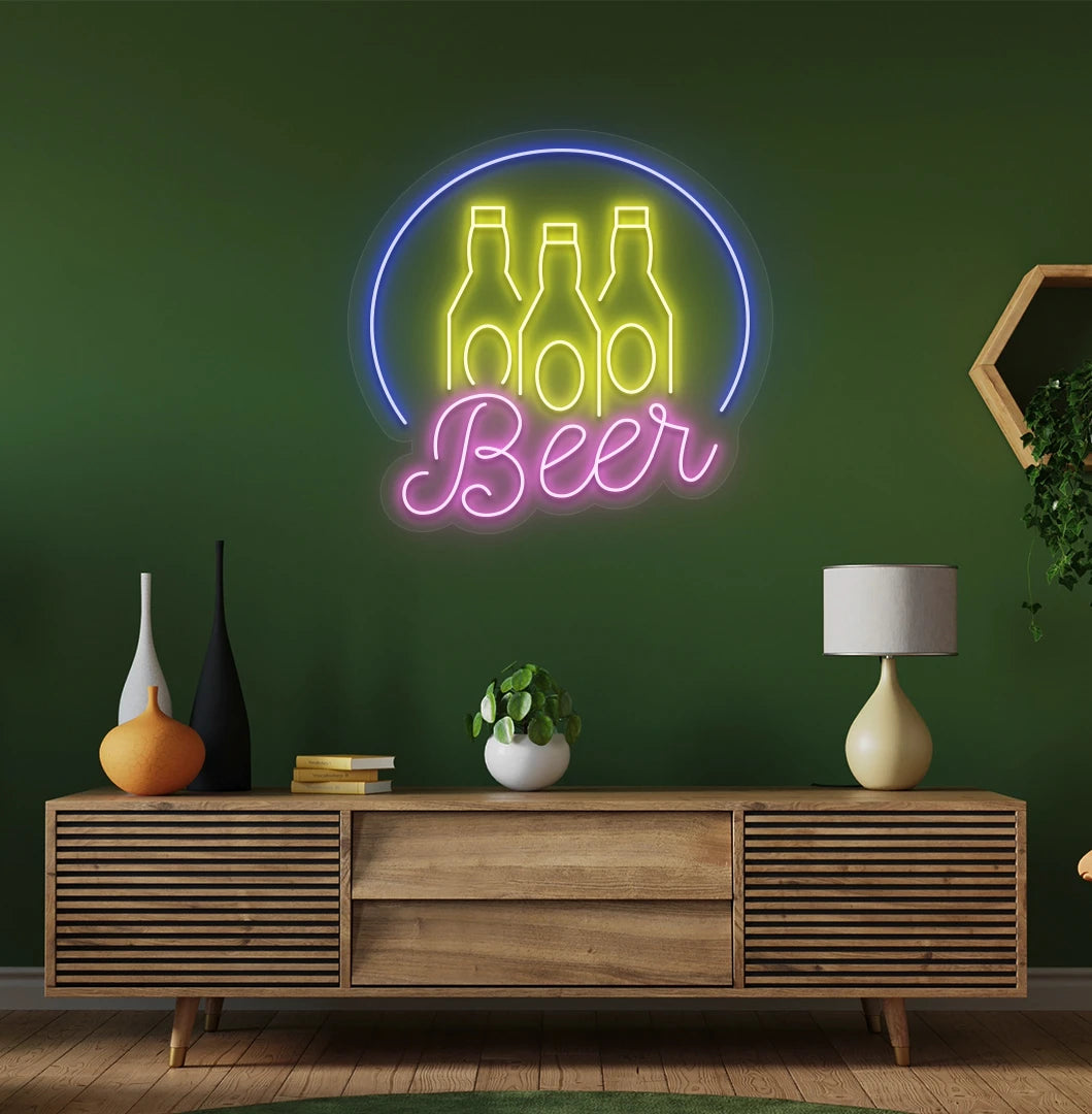 Modern wall decor with beer text and bottles neon sign glowing pink.