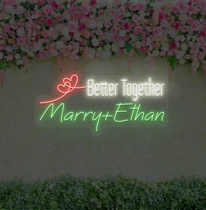 Personalized Better Together neon sign with custom names mounted on modern wedding backdrop wall in green color.