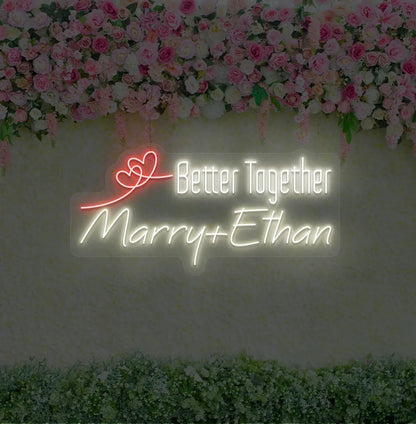Personalized Better Together neon sign with custom names mounted on modern wedding backdrop wall in warm white color.