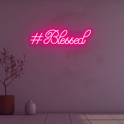 Stylish blessed pink LED neon sign mounted on wall. 