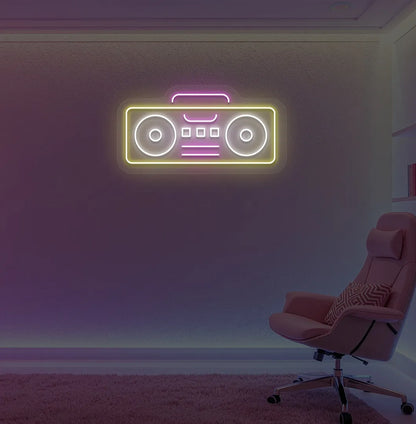 Stylish boombox LED neon sign in yellow mounted on gaming room wall.