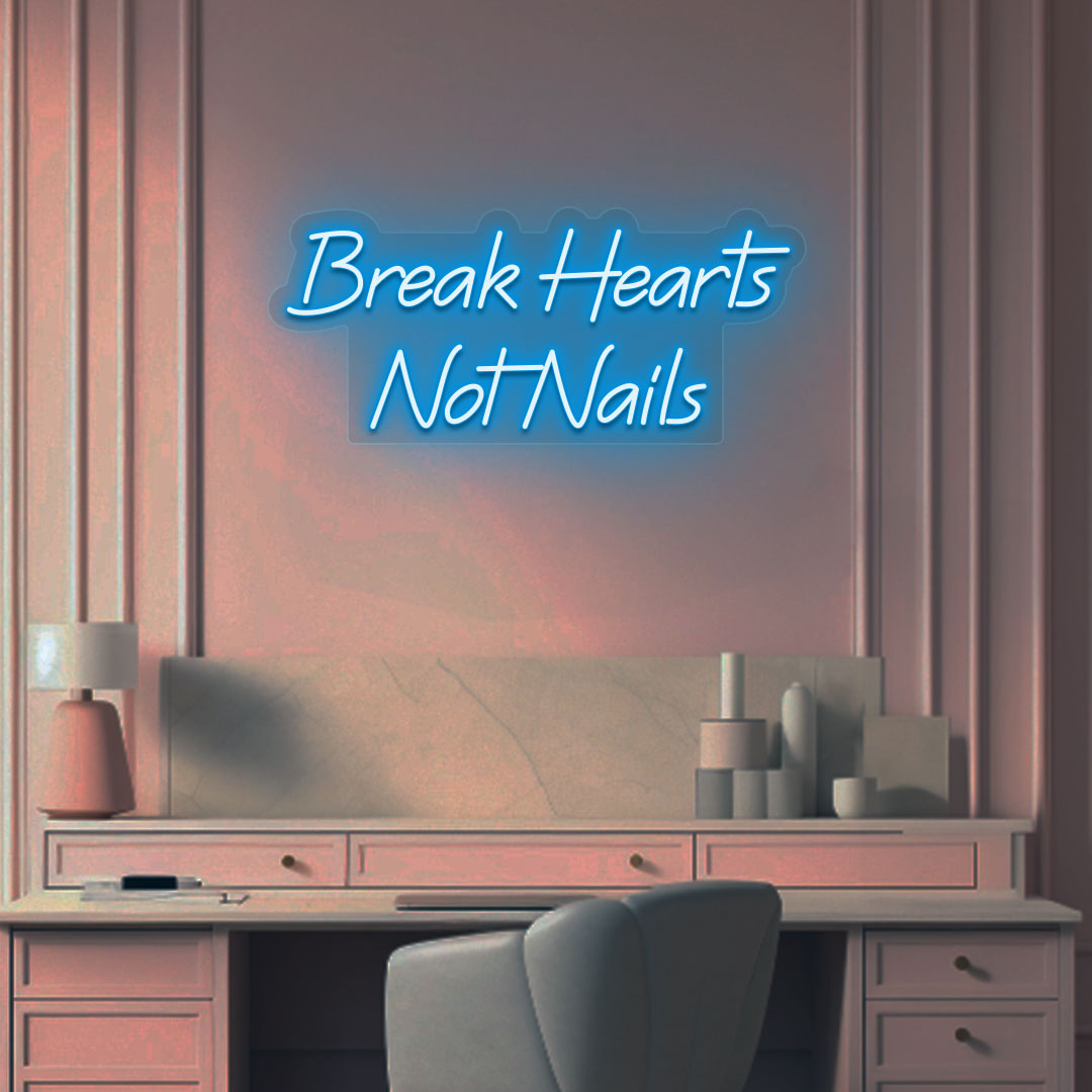 Stylish "break hearts, not nails" neon sign in ice blue on the wall. Perfect for nail salons, beauty studios, and home nail art setups.