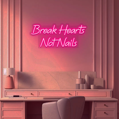 Beauty studio wall with break hearts, not nails neon sign glowing pink.