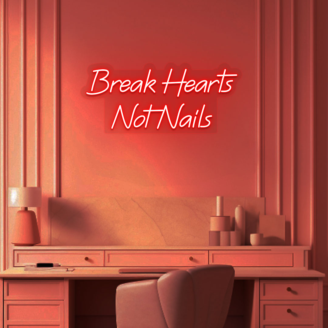 Stylish "break hearts, not nails" neon sign in red on the wall. Perfect for nail salons, beauty studios, and home nail art setups.