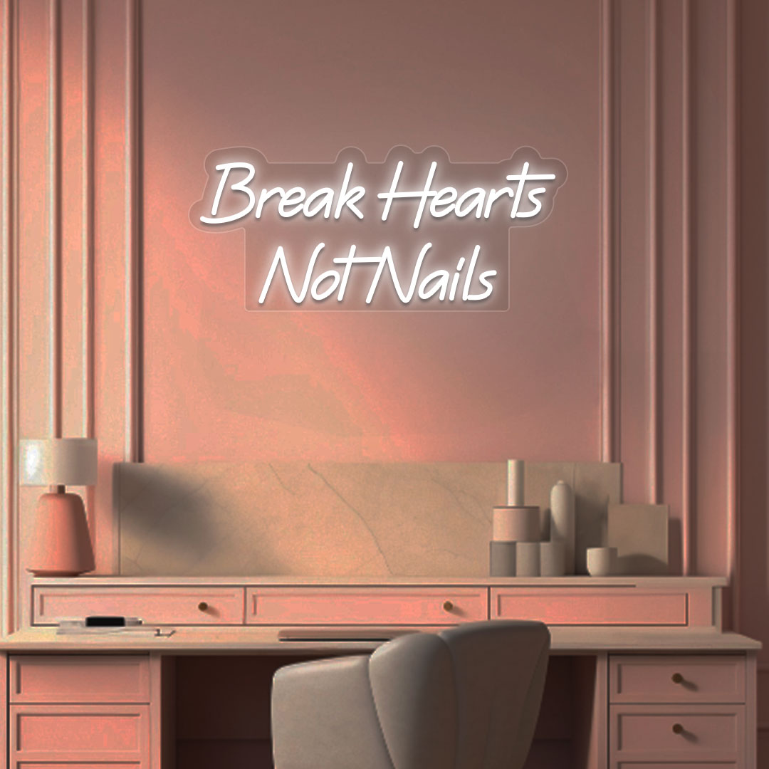 Stylish "break hearts, not nails" neon sign in white on the wall. Perfect for nail salons, beauty studios, and home nail art setups.