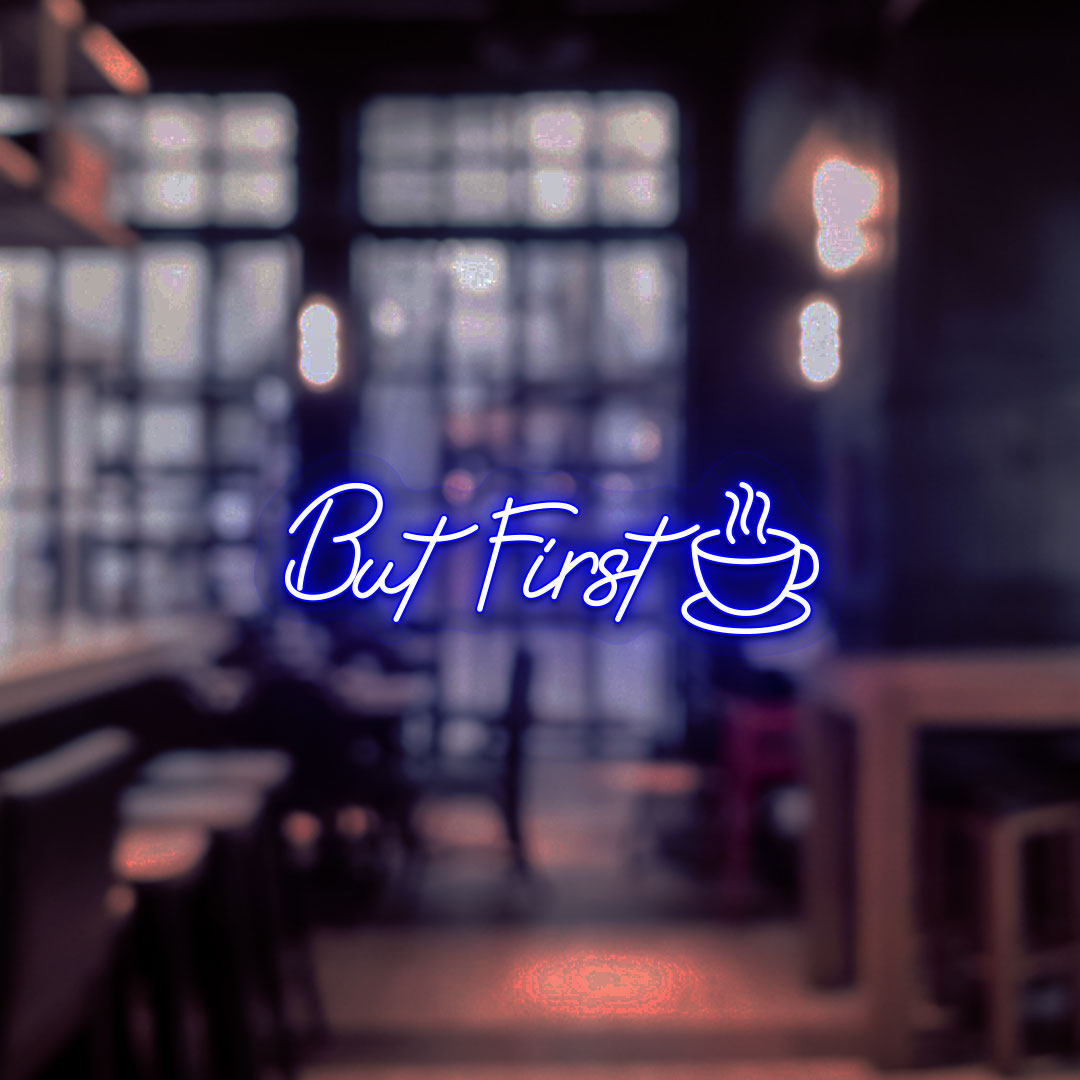 Coffee shop entrance, but first a neon sign and cup icon glowing in blue.