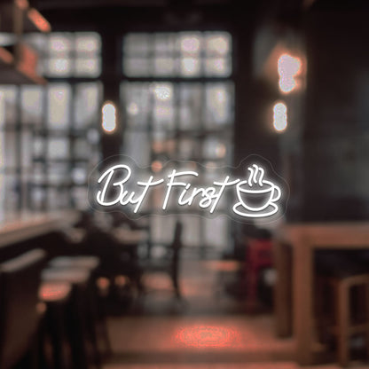 Coffee shop entrance, but first a neon sign and cup icon glowing in white.
