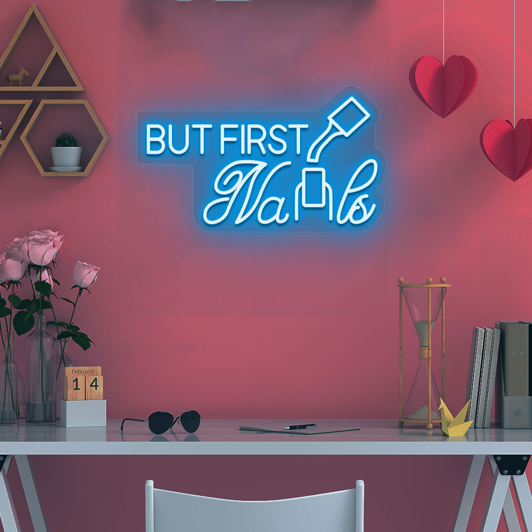 Beauty studio decor with an ice blue LED "but first nails" neon sign glowing on the wall.