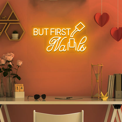 Stylish orange LED "But First Nails" neon sign mounted on salon wall. Perfect for nail salons, beauty studios, home nail art spaces, and salon storefront displays.