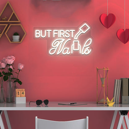 Stylish white LED "But First Nails" neon sign mounted on salon wall. Perfect for nail salons, beauty studios, home nail art spaces, and salon storefront displays.