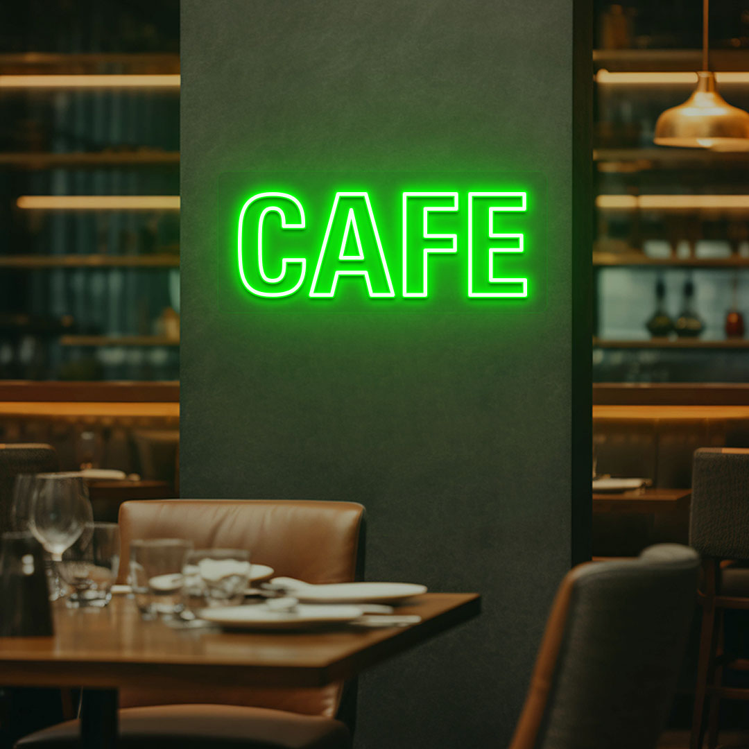 Coffee shop wall with green LED cafe neon sign glowing.