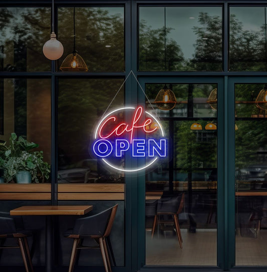 Image of a cafe's open neon sign glowing on the cafe glass door in blue.