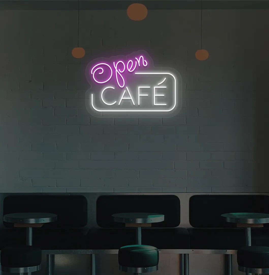 Image of a cafe wall with pink cafe open neon sign glowing brightly.