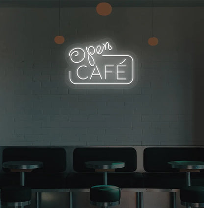 Image of a cafe wall with white cafe open neon sign glowing brightly.