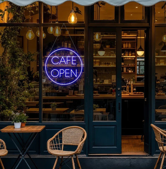 Image of a stylish cafe open in circle neon sign in blue mounted on cafe wall.