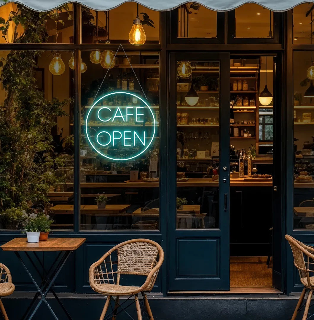 Image of a stylish cafe open in circle neon sign in ice blue mounted on cafe wall.