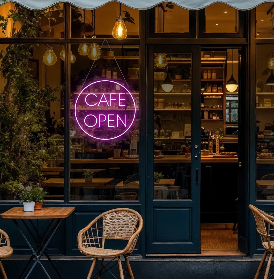 Image of a stylish cafe open in circle neon sign in pink mounted on cafe wall.