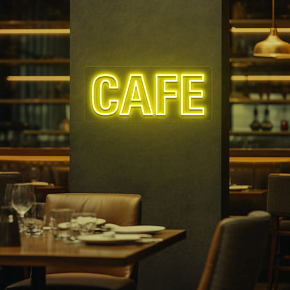 Coffee shop wall with yellow LED cafe neon sign glowing.
