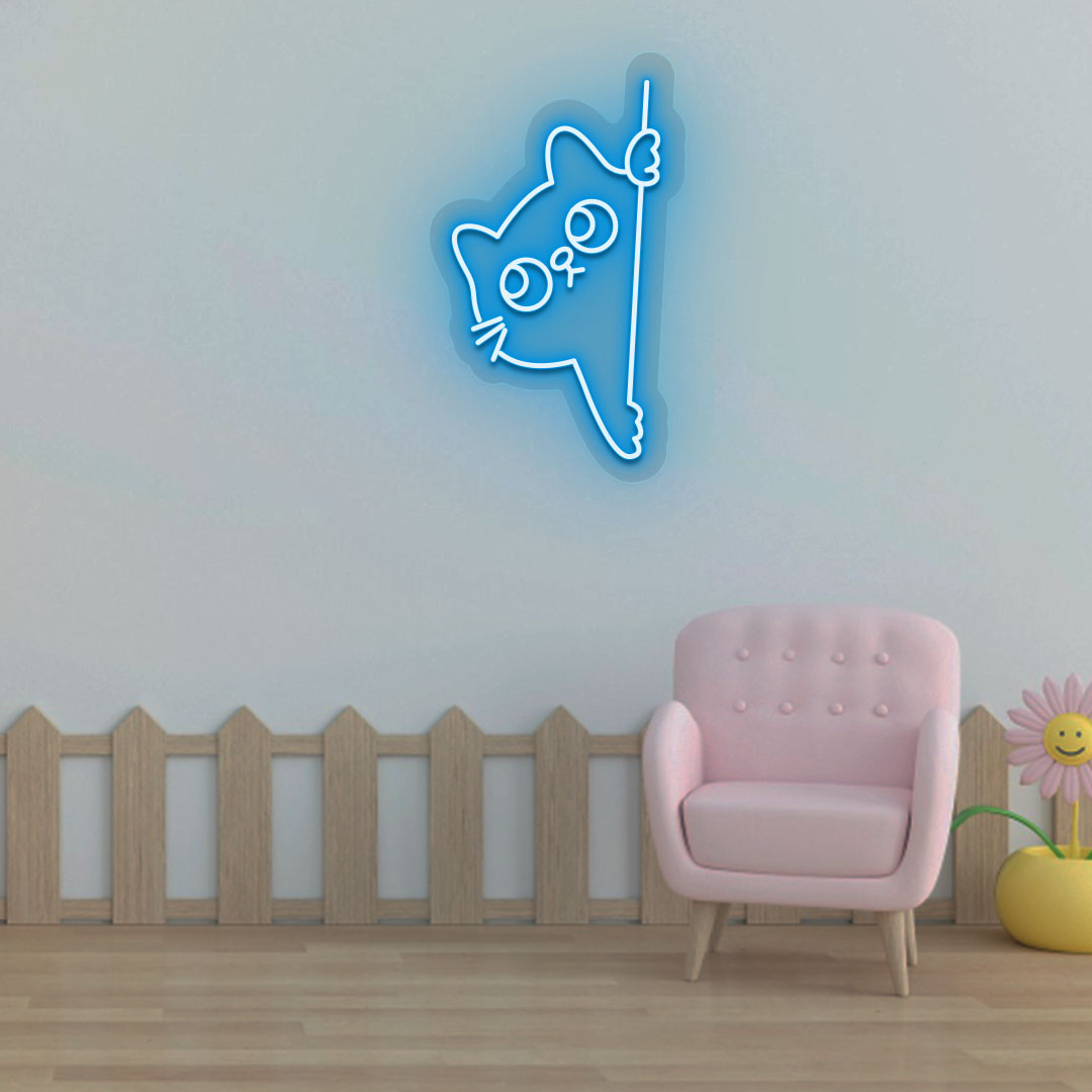 A cute peeking cat ice blue LED neon sign is glowing on the wall. Perfect for kids’ rooms, nurseries, playrooms, and activity areas.