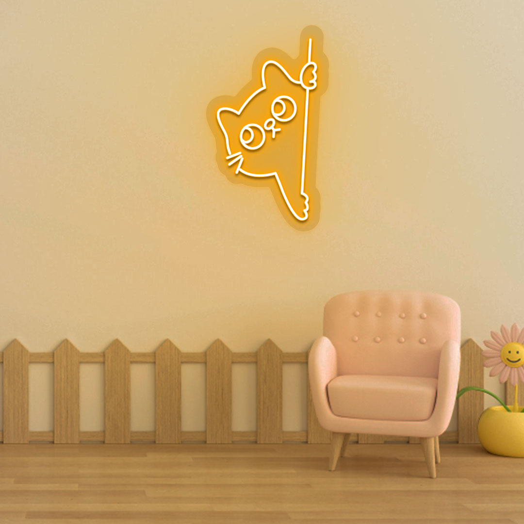 Image of a peeking cat LED neon sign hanging on a kid's bedroom wall in orange color.