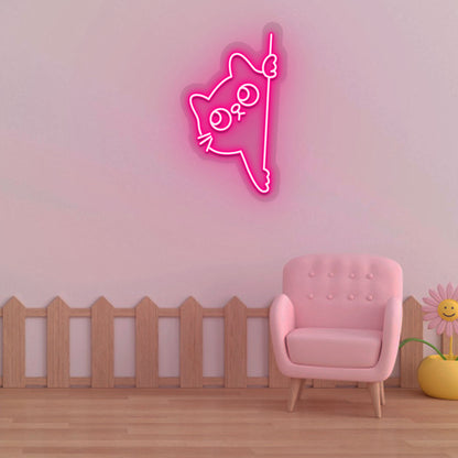 Stylish pink LED cat neon sign peeking design mounted on kids' room wall.
