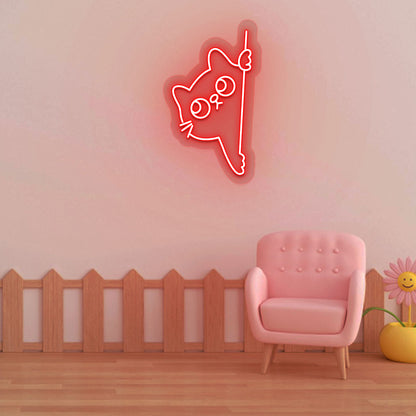 Stylish red LED cat neon sign peeking design mounted on kids' room wall.