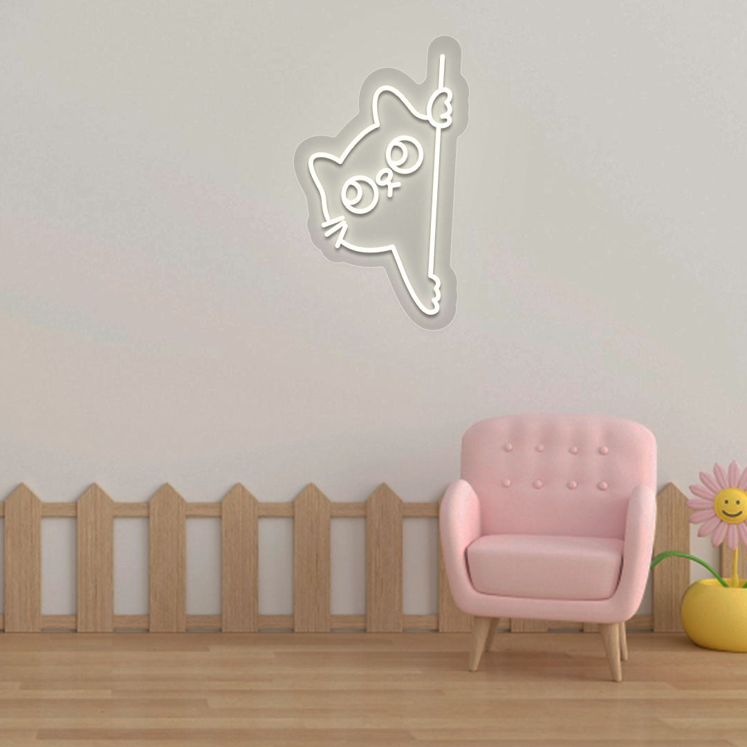A cute peeking cat warm white LED neon sign is glowing on the wall. Perfect for kids’ rooms, nurseries, playrooms, and activity areas.