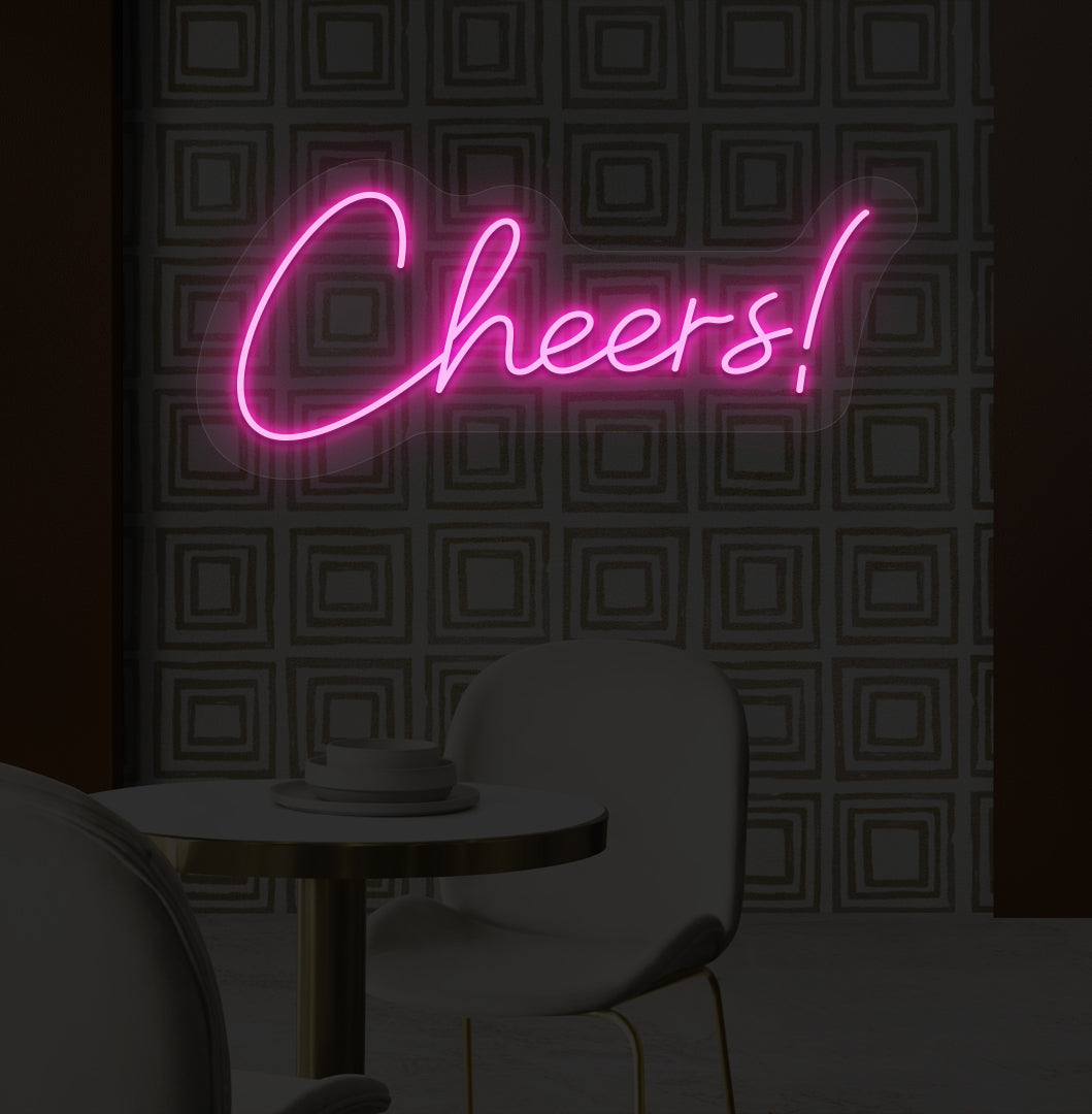 Decorative pink LED cheers neon sign glowing on bar wall.