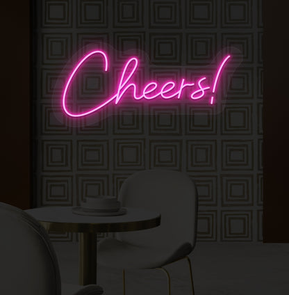 Decorative pink LED cheers neon sign glowing on bar wall.