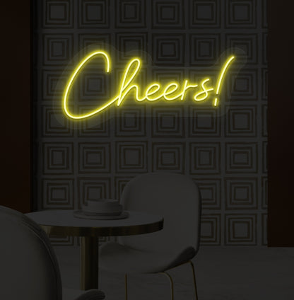 Image of a "cheers" LED neon sign mounted on a modern bar wall in yellow color.