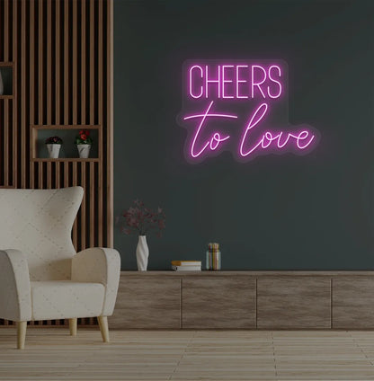 Image of a Romantic Cheers to Love purple neon sign glowing on decorative wall.