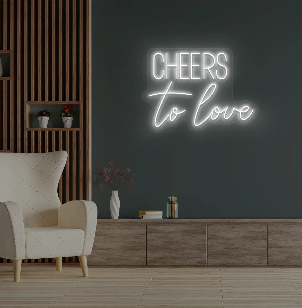 Modern wedding backdrop featuring Cheers to Love white neon sign.