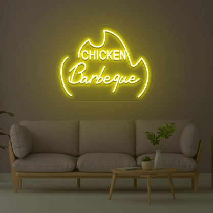 A stylish chicken barbeque yellow LED neon sign is hanging on the wall. Perfect for barbeque restaurants, food outlets, and street food shops.