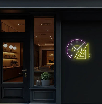 Stylish "24 hour clock" neon sign in yellow mounted on storefront wall.