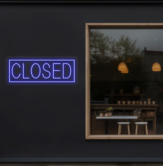 Image of a closed neon sign glowing on shop exterior wall in blue color.