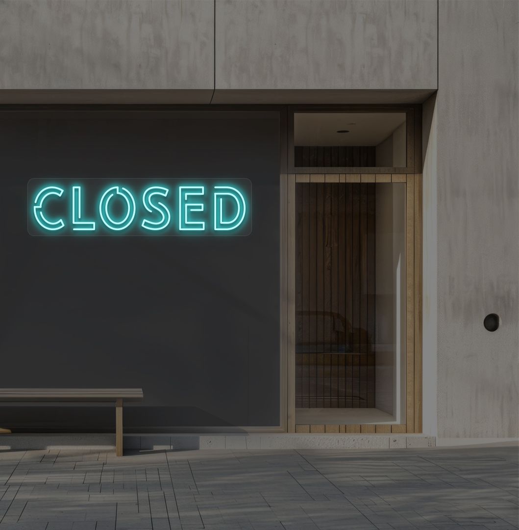 Image of a closed bold neon sign glowing on a shop exterior wall in ice blue.