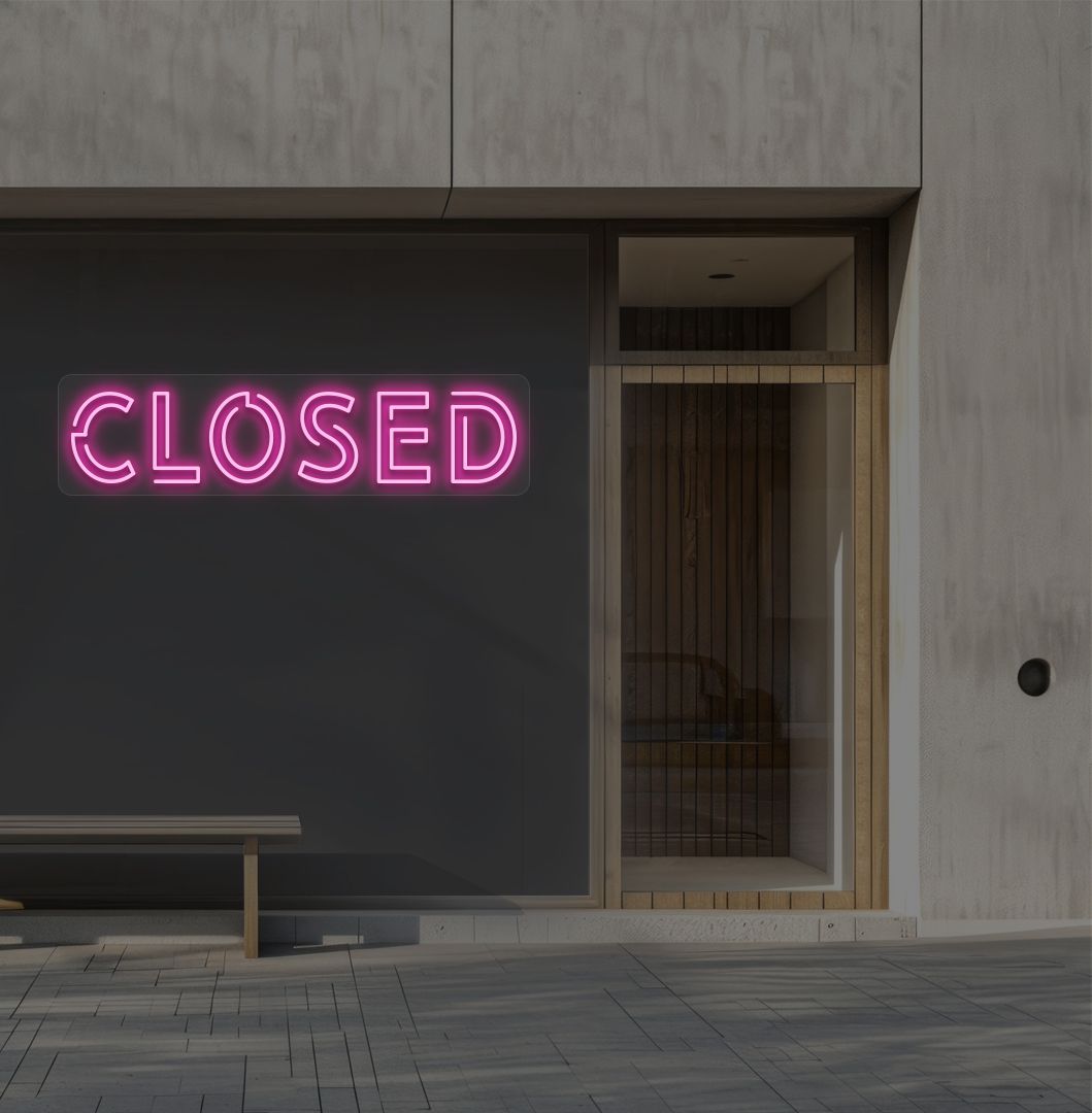 Image of a closed bold neon sign glowing on a shop exterior wall in pink.