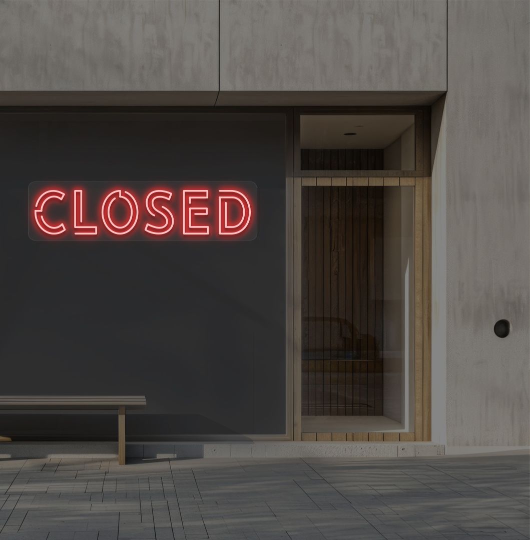 Image of a closed bold neon sign glowing on a shop exterior wall in red.